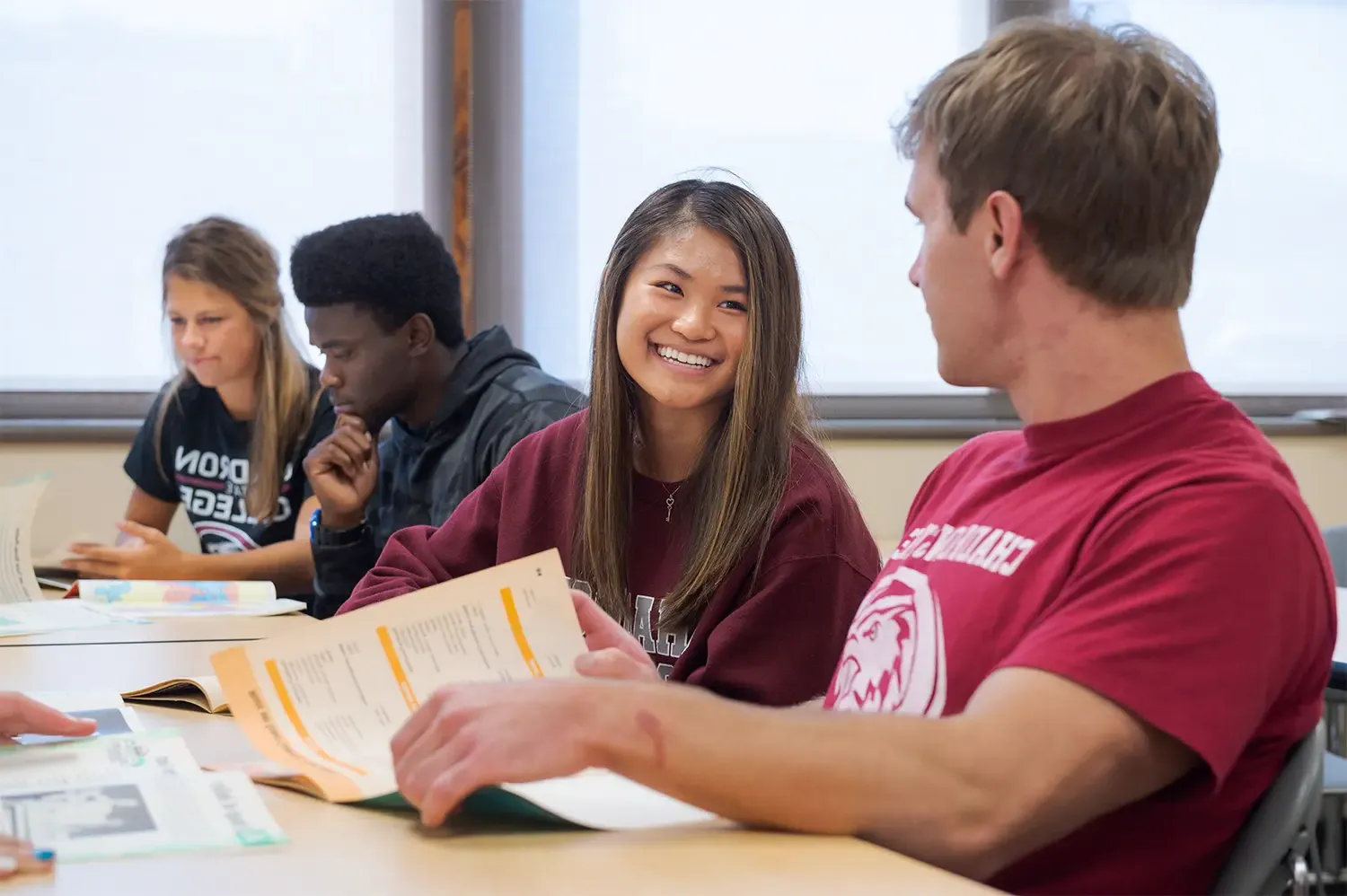 Several students laugh during a classroom discussion